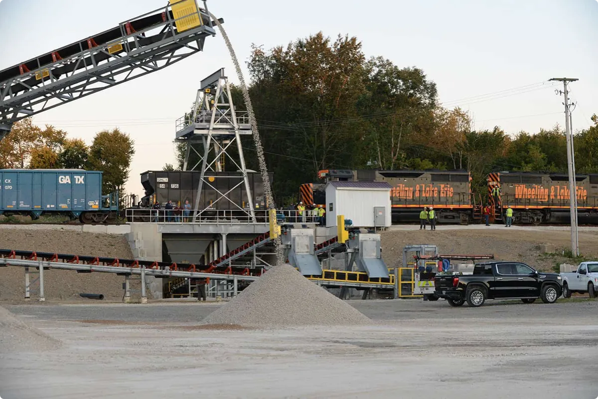 trucks being loaded with rocks